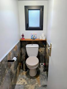 a bathroom with a toilet and a window at Le Chant des Arbres in Grane +7 photos