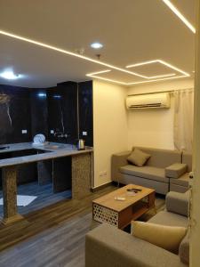 a living room with a couch and a table at Gulf Suites Cairo in Cairo