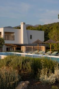a resort with a swimming pool and a building at VILLA FLAKA Boutique Hôtel Wellness in Cargèse
