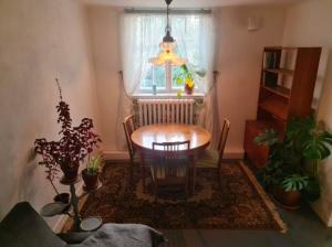 a dining room with a table and some plants at Nice and cosy flat in Molkom