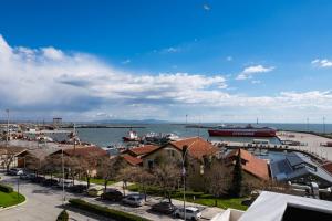 a view of a harbor with a boat in the water at Oniro Suites Level 4 in Alexandroupoli