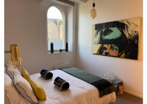 a bedroom with a bed with two pillows on it at Barfleur in Barfleur