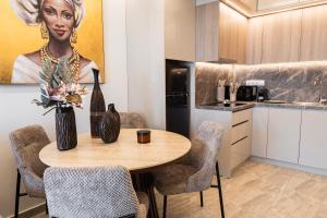 a kitchen with a table with a vase of flowers at Oniro Suites Level 4 in Alexandroupoli