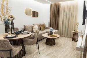 a living room with a couch and a table at Oniro Suites Level 4 in Alexandroupoli