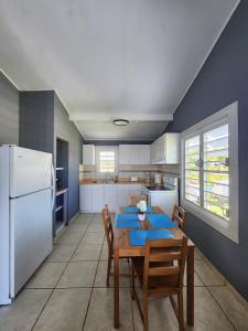 a kitchen with a table and a white refrigerator at Costa Azul Apartment in Punta Santiago