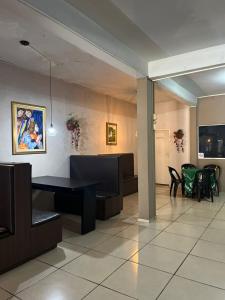 a lobby with a waiting room with a table and chairs at Ambassador Hotel in Foz do Iguaçu