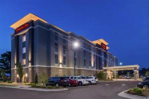 a hotel with cars parked in a parking lot at Hampton Inn Benson in Benson