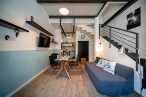 a living room with a blue couch and a table at Cosy Moods - OldTown in Trieste
