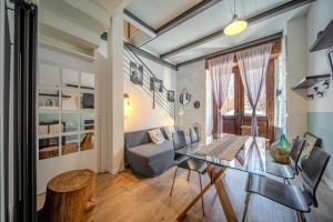 a living room with a glass table and a couch at Cosy Moods - OldTown in Trieste