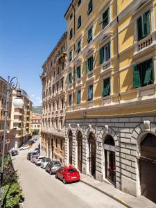 a red car parked in front of a building at Cosy Moods - OldTown in Trieste