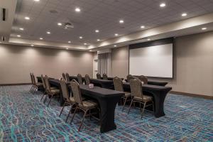 a conference room with tables and chairs and a screen at Hampton Inn Benson in Benson +51 photos