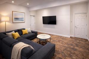 a living room with a couch and a tv at The Miles Arms Hotel in Avonmouth