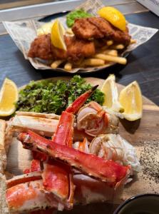 a plate of food with lobster and other foods at Holiday Suite in Bugøynes