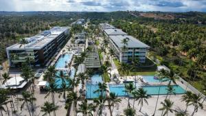 an aerial view of a resort with a pool at Apartamento Ipioca Beach Life - Maceió in Maceió