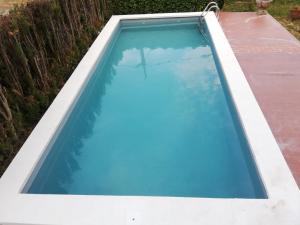 an overhead view of a swimming pool with blue water at Un lugar tranquilo y relajado en Pedrasanta in La Salud