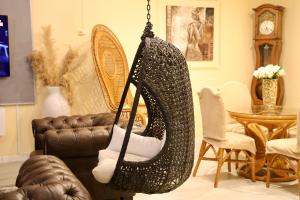 a black hammock hanging in a living room at Domaine Maud-Le Néoma-confort ! 50m plage in Saint-Pierre