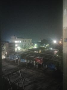 a view of a city at night with lights at Morisika lodge in Guwahati