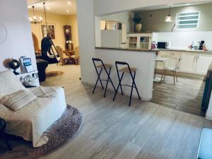 a living room and kitchen with a table and chairs at Domaine Maud-Le Néoma-confort ! 50m plage in Saint-Pierre