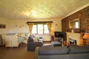 a living room with a couch and a fireplace at Bodhyfryd in Llanfairpwllgwyngyll