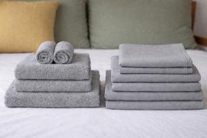 a pile of towels sitting on top of a bed at Departamento Palomar in Posadas