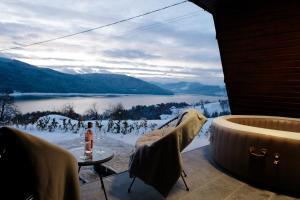 a room with a view of a lake and snowy mountains at Azimuth in Buhalniţa