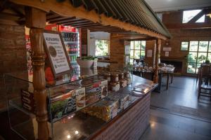 a restaurant with a counter with food on it at Green House in Villa General Belgrano