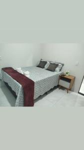 a bedroom with a bed and a wooden table at Pousada Casa do Arthur in Barreirinhas +28 photos