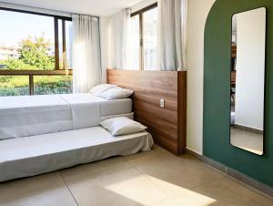 a bedroom with two beds and a mirror at Porto de Galinhas PORTO EXCLUSIVE BY AFT in Porto De Galinhas +16 photos