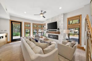 a living room with a couch and a fireplace at Brighton Cottage in Rosemary Beach