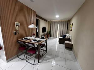 a living room with a table and a couch at Vg Sun Cumbuco 112 in Caucaia