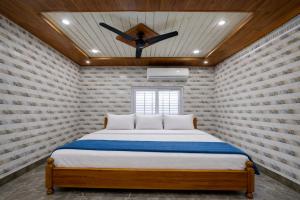 a bedroom with a bed with a ceiling fan at Lakshmi Divya Guest house in Pedda Ahobilam