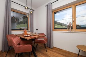 a dining room with a table and chairs and a window at Apartment Alpbachtraum in Alpbach