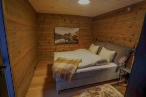 a small room with a bed in a log cabin at Mountain View Apartment 201 in Stranda