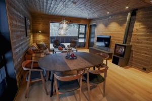 a dining room with a table and chairs and a tv at Mountain View Apartment 201 in Stranda