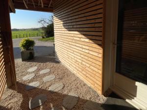 a door to a house with a shadow on the wall at Chez Fab in Ferrières-lès-Ray