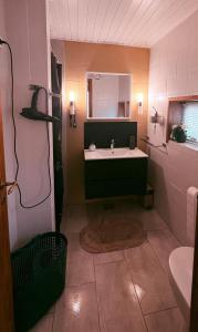 a bathroom with a sink and a mirror at Family room in centrum 300m to Lego House and walking street in Billund