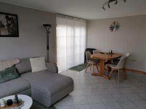 a living room with a couch and a table at Die kleine Feine in Olmscheid
