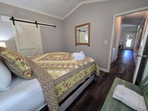 a bedroom with a bed and a mirror and a door at Romantic Getaway Hot Tub Keyless Arrival in Broken Bow