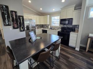 a kitchen with a table and chairs in it at Romantic Getaway Hot Tub Keyless Arrival in Broken Bow