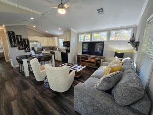 a living room with a couch and a table at Romantic Getaway Hot Tub Keyless Arrival in Broken Bow