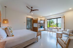 a bedroom with a bed and a living room at Punta Mita 4BR Paradise Golf Course Views in Punta Mita +22 photos