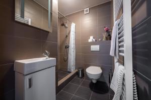 a small bathroom with a toilet and a sink at Chata Majocka Martin Strane, Ferrata in Martin +8 photos