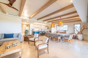 a living room with a couch and a table at Punta Mita 4BR Paradise Golf Course Views in Punta Mita