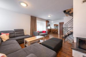 a living room with a couch and a table at Chata Majocka Martin Strane, Ferrata in Martin