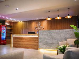 a hotel lobby with a reception desk with a pong sign at Porto de Galinhas PORTO EXCLUSIVE BY AFT in Porto De Galinhas