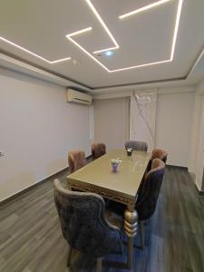 a conference room with a table and chairs at Gulf Suites Cairo in Cairo