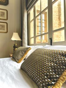 a bedroom with a large bed with a large window at Casona de Santa Ana in Cuevas Bajas