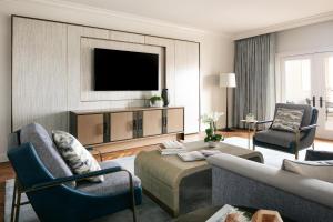 a living room with a couch and a tv at Waldorf Astoria Monarch Beach Resort & Club in Dana Point