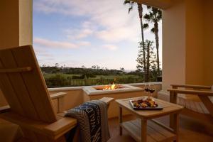 a room with a large window with a fire pit at Waldorf Astoria Monarch Beach Resort & Club in Dana Point