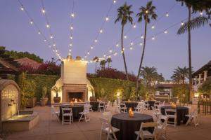 a patio with tables and chairs and a fireplace at The Scottsdale Resort & Spa, Curio Collection by Hilton in Scottsdale